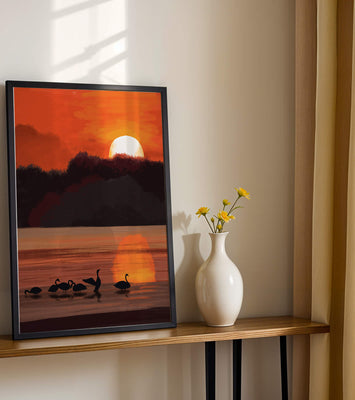 Serene sunset over a lake with silhouetted swans
