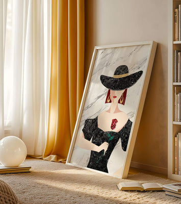 Elegant woman in wide-brimmed hat holding a rose on marble background