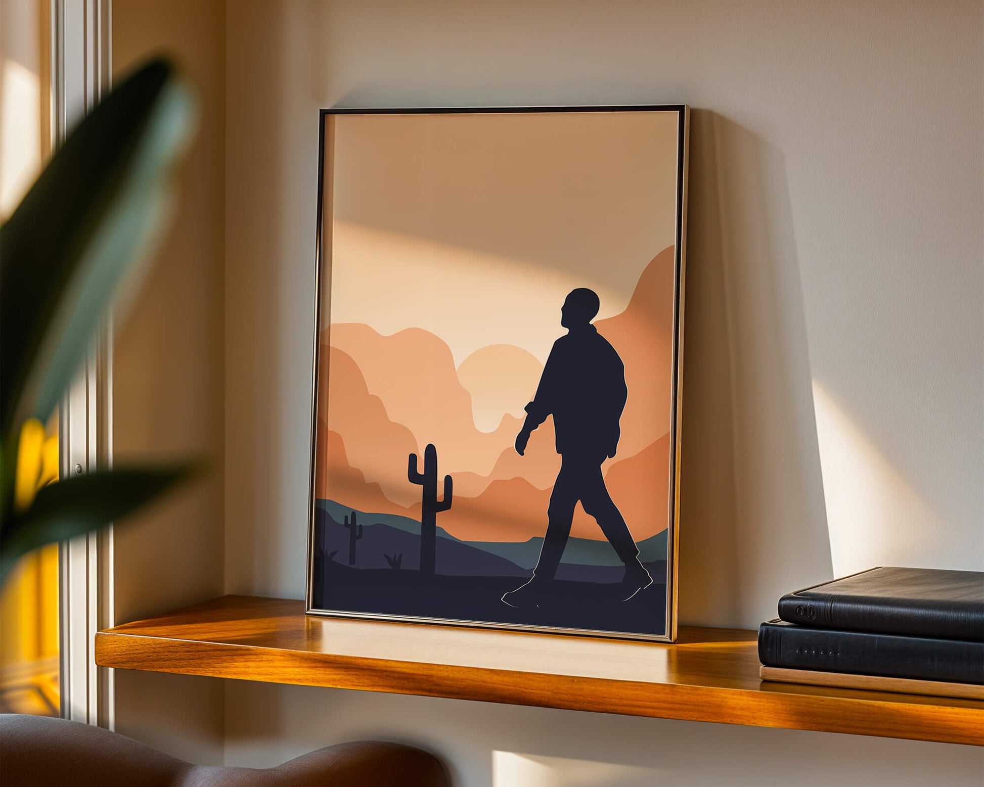 Silhouetted figure walking in desert landscape at sunset