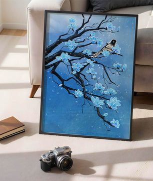 Bird on a branch with blue flowers against a snowy background