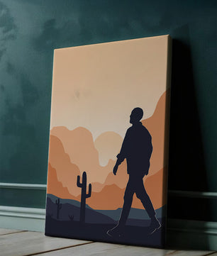 Silhouetted figure walking in desert landscape at sunset