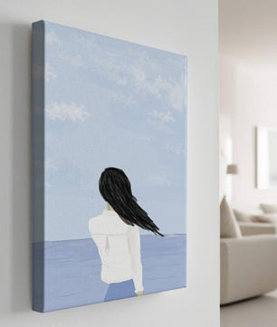 Woman gazing at the ocean with blue sky and clouds