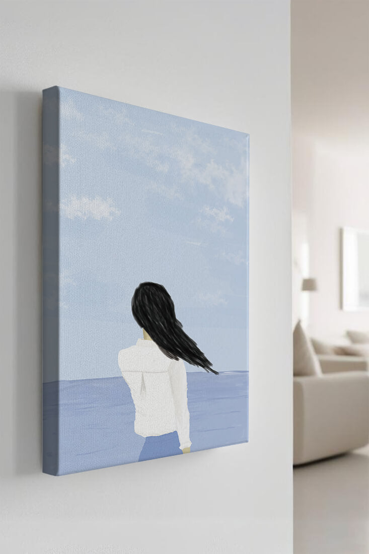Woman gazing at the ocean with blue sky and clouds