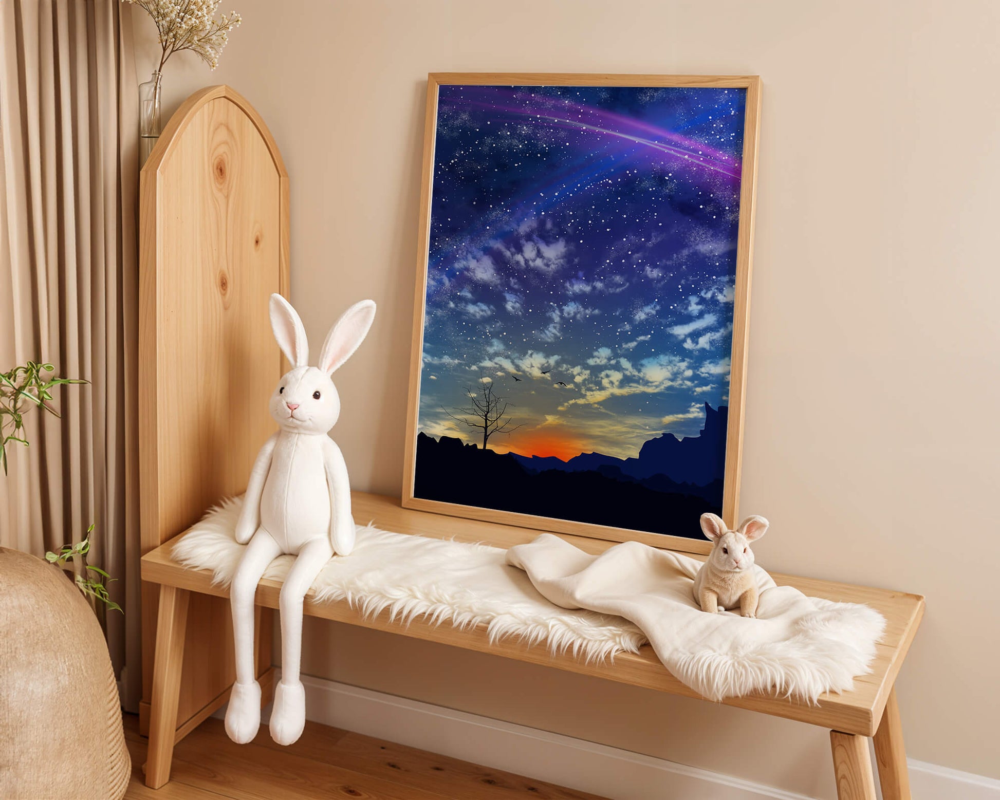 Starlit night sky with colorful sunset and silhouetted landscape