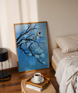Bird on a branch with blue flowers against a snowy background