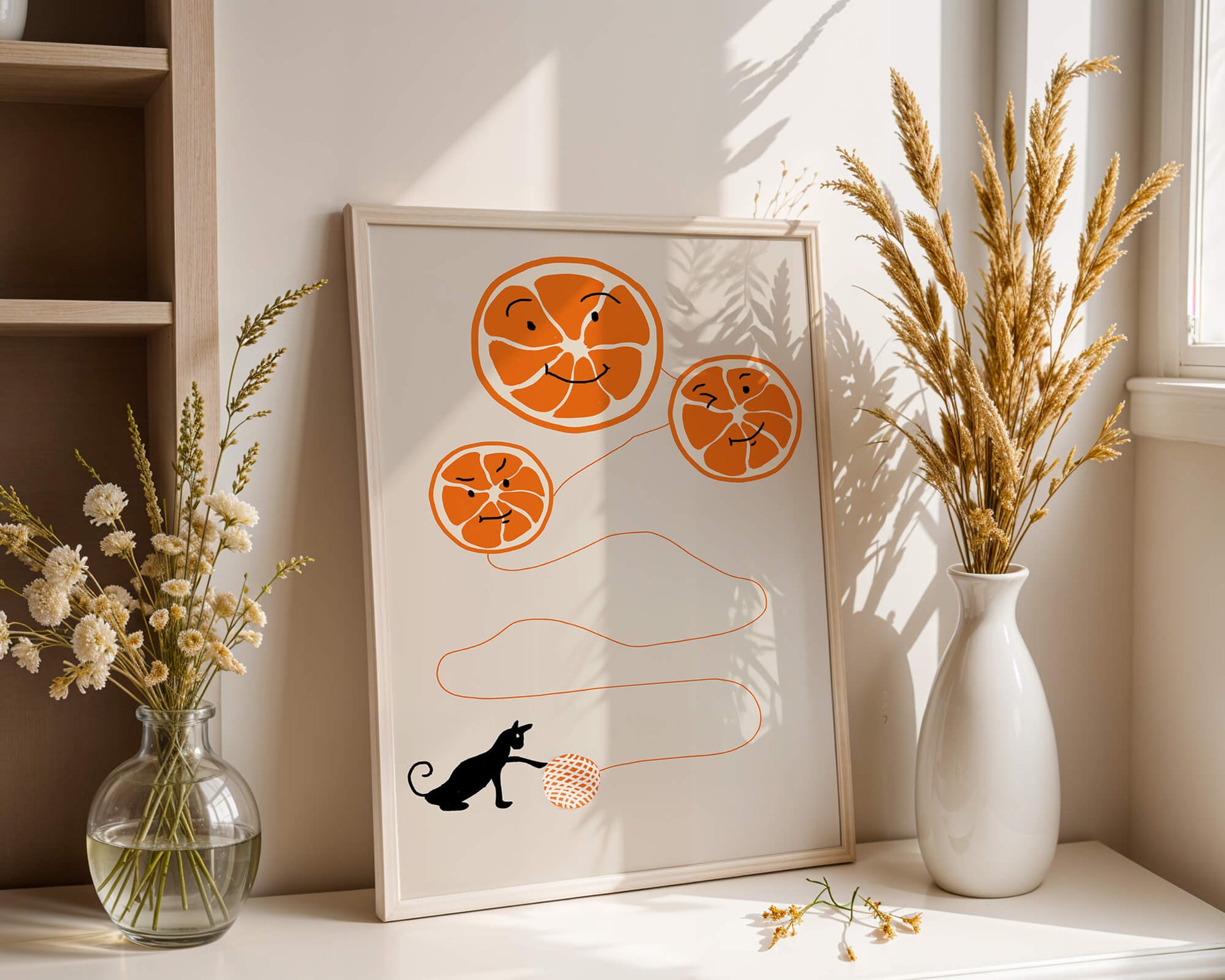 Playful illustration of oranges with cat and yarn