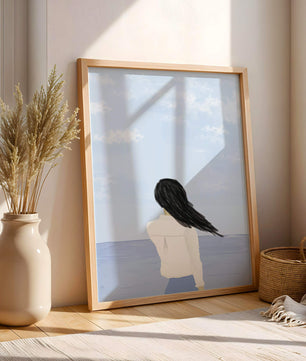 Woman gazing at the ocean with blue sky and clouds