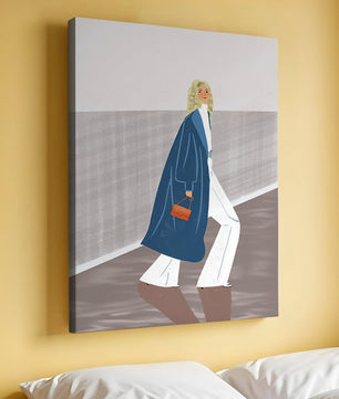 Fashionable Woman in Long Blue Coat Walking Along Corridor with Orange Handbag