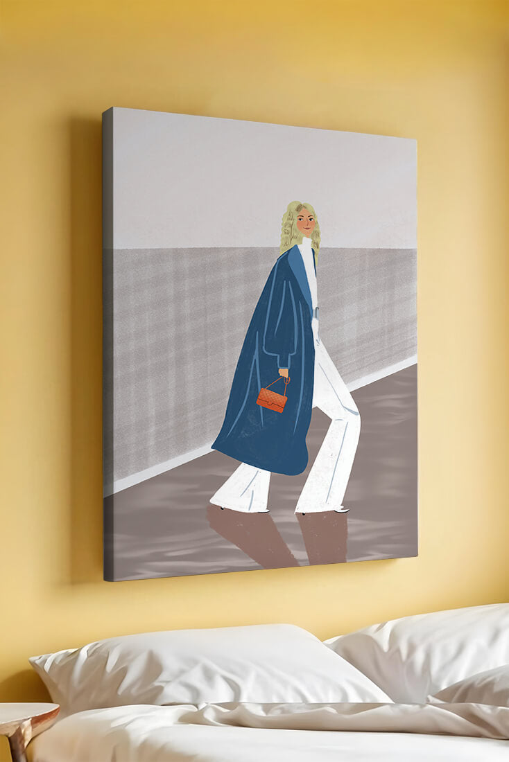 Fashionable Woman in Long Blue Coat Walking Along Corridor with Orange Handbag