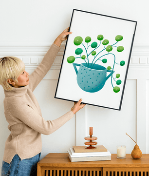 Ilustración minimalista de una planta pilea verde en una maceta de cerámica azul